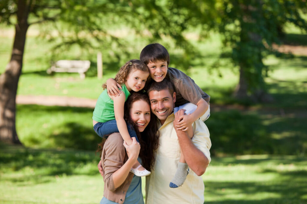 parents giving children piggyback